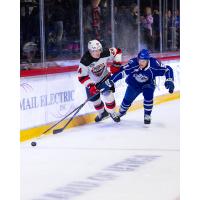 Syracuse Crunch defenseman Derrick Pouliot (right) vs. the Utica Comets